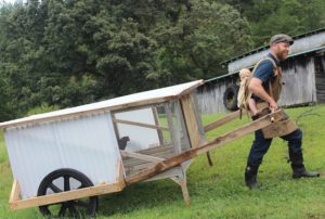 Justin with his mobile coop, the "Chickshaw" (Photo: Justin Rhodes/Abundant Permaculture)